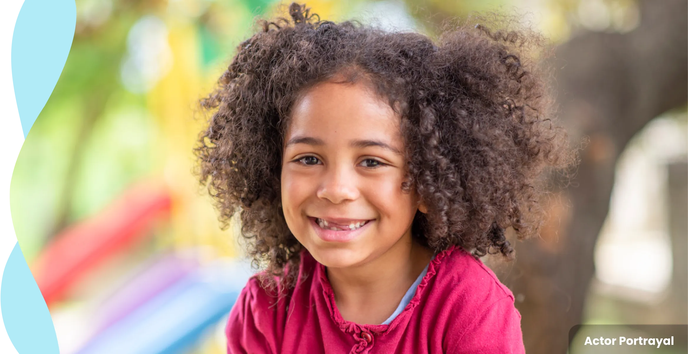 Young girl smiling with baby teeth missing, wearing a pink shirt. Actor portrayal.