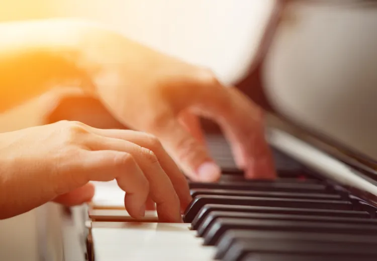 Child's hands playing a piano