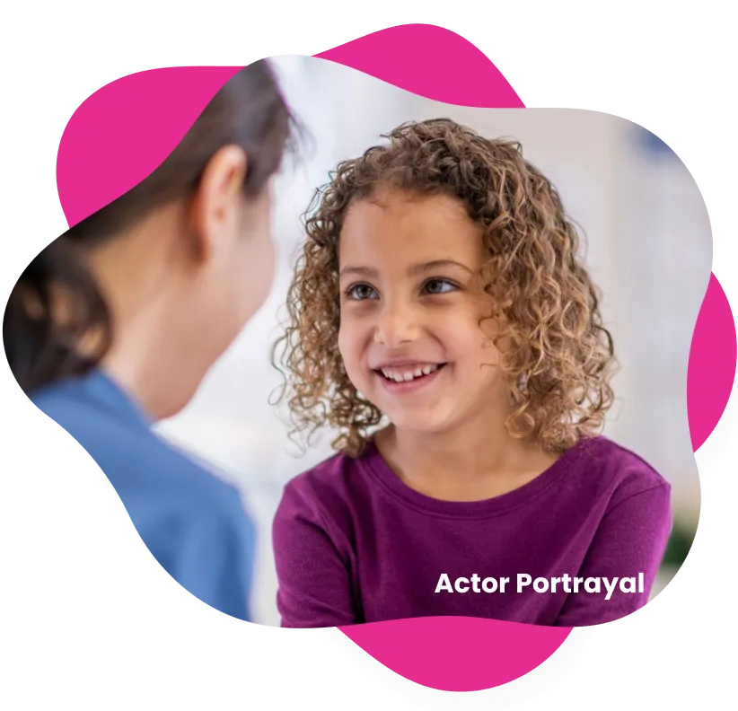 Young girl with wavy hair, wearing a purple shirt, talking with an adult. Actor portraval.