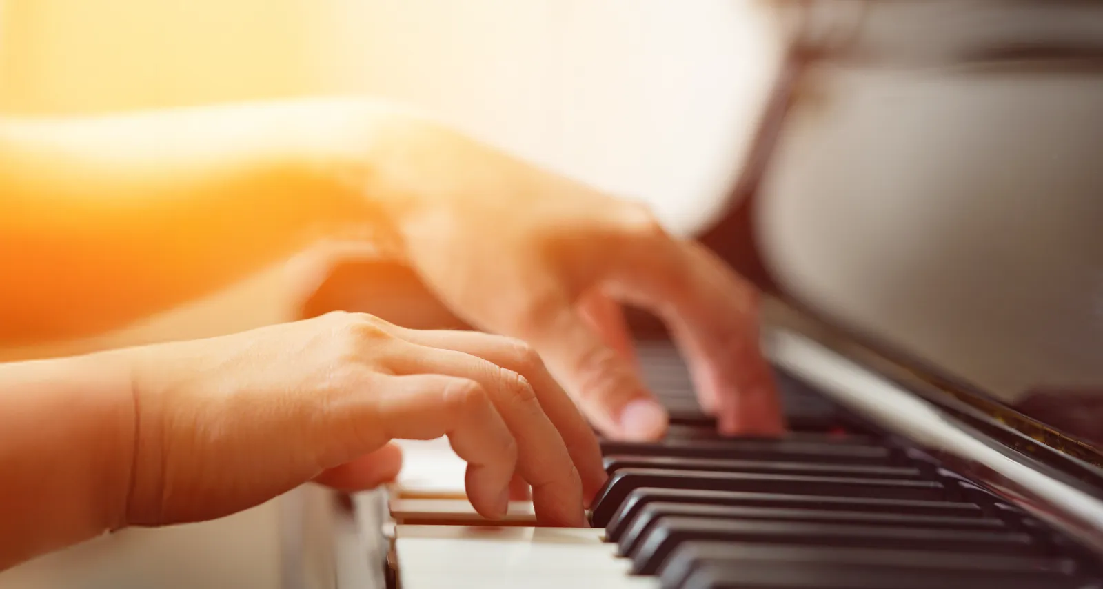 Child's hands playing a piano